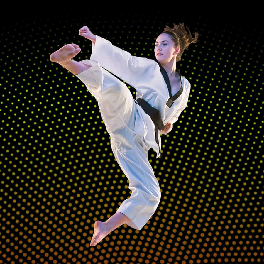 Martial Arts Lessons for Adults in Ashburn VA - Girl Black Belt Jumping High Kick