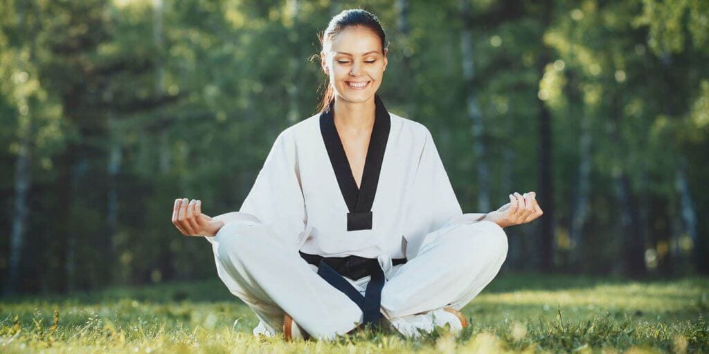 Martial Arts Lessons for Adults in Ashburn VA - Happy Woman Meditated Sitting Background